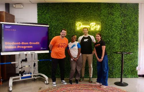 4 people from credit union standing next to smartboard